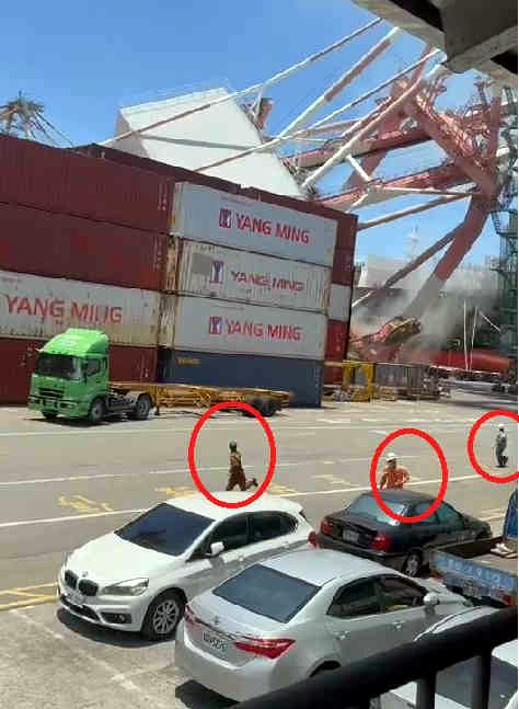 Workers are seen running as cranes begin to collapse after ship collision at the Port of Kaohsiung, June 3, 2021.
